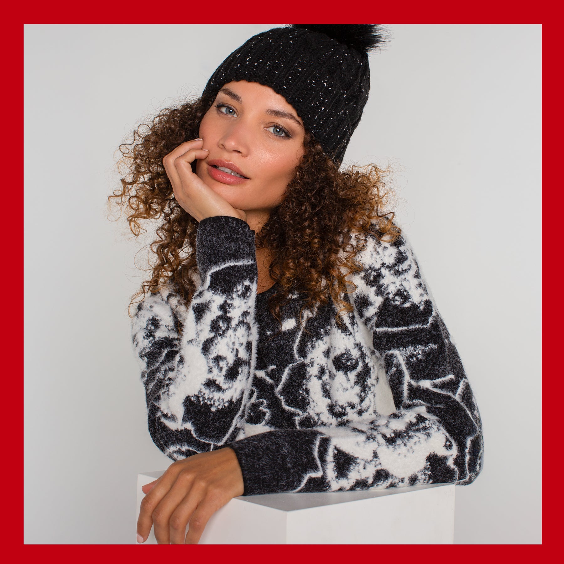 Woman wearing black knit hat and patterned sweater