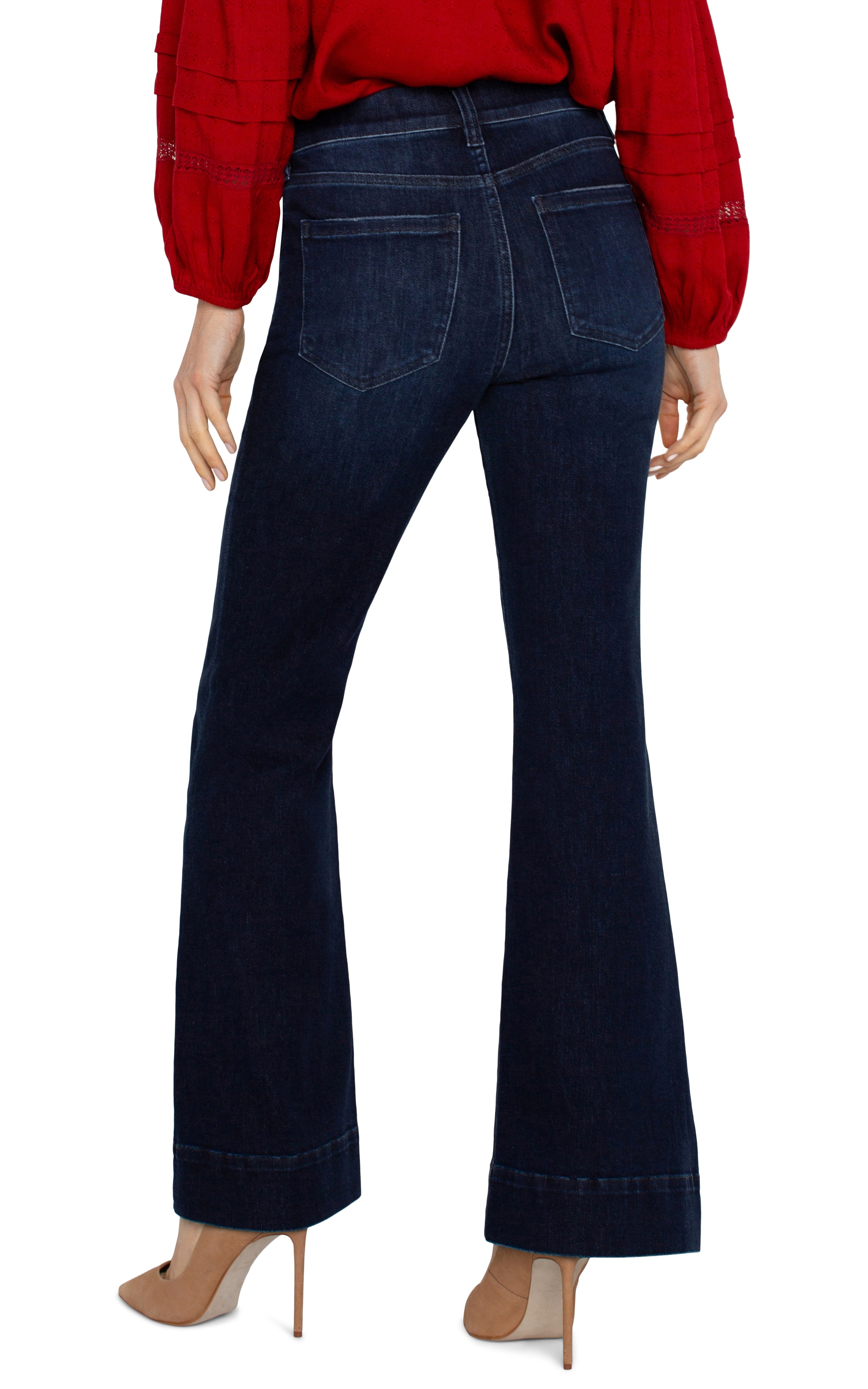 woman wearing dark flared jeans with red blouse and heels, back view