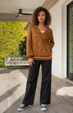 woman wearing stylish oversized sweater and wide-leg pants casual fashion outdoor setting