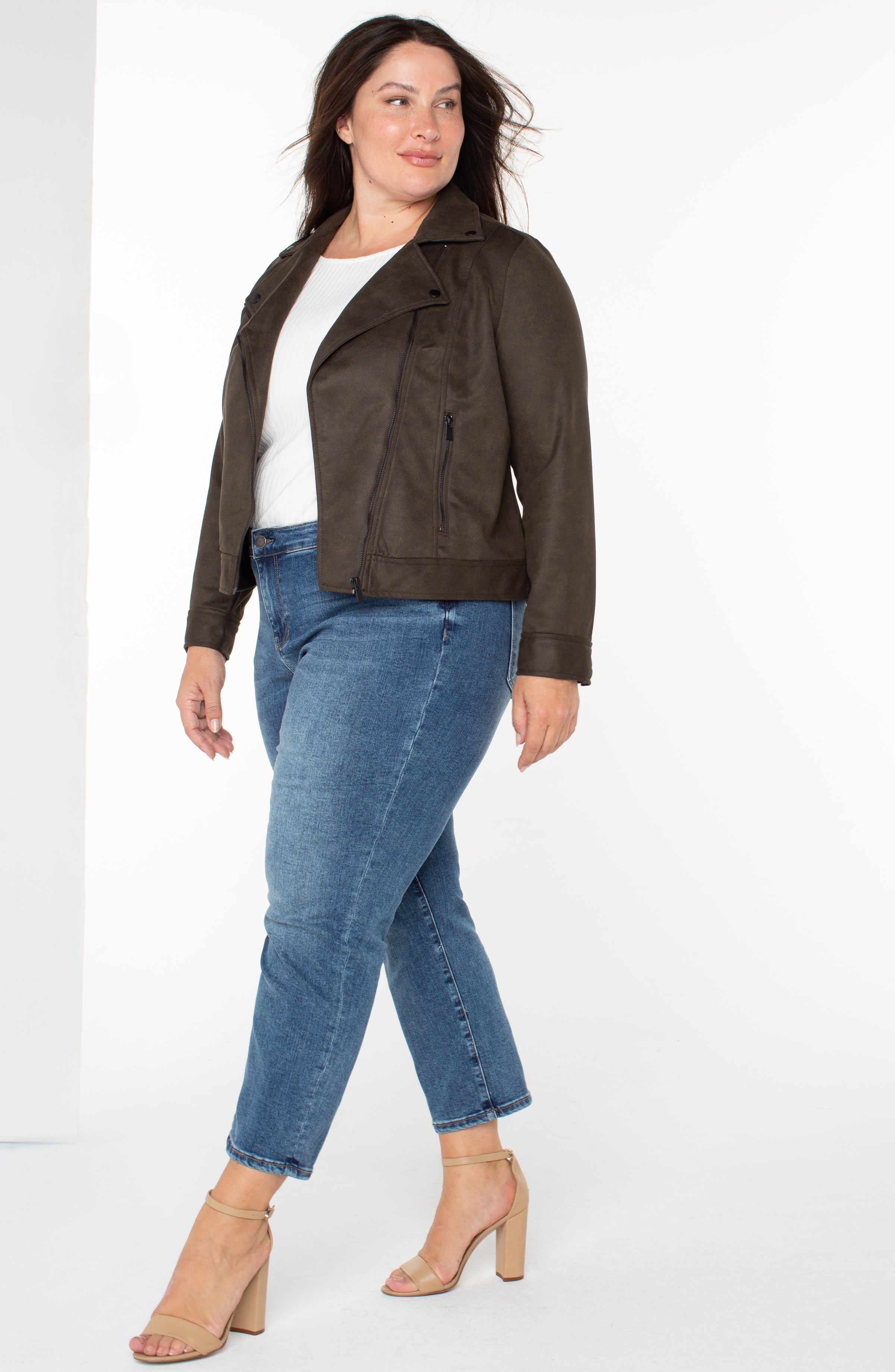 plus size woman wearing brown leather jacket and jeans