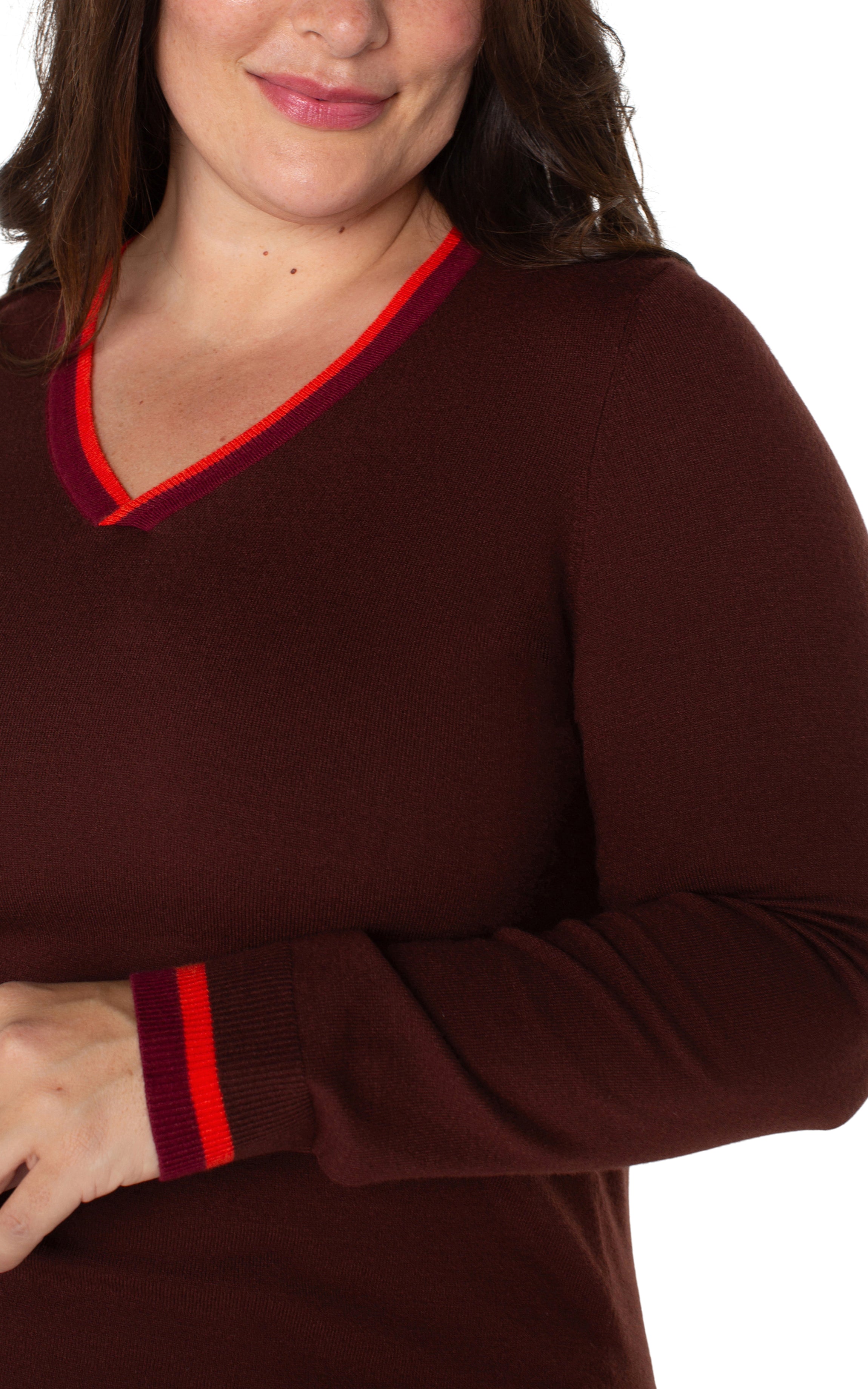 plus-size woman wearing burgundy sweater with v-neck and striped sleeves