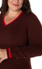 plus-size woman wearing burgundy sweater with v-neck and striped sleeves